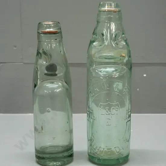 2 codd marble bottles - Lane & Co Dunedin with clear marble, a few chips, and smaller one with black or dark green