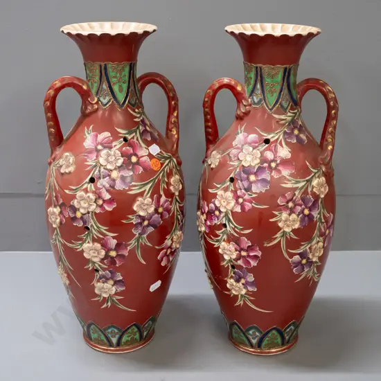 pair of handled vases with applied flowers and Satsuma style decoration, with lines of holes in sides, some staining