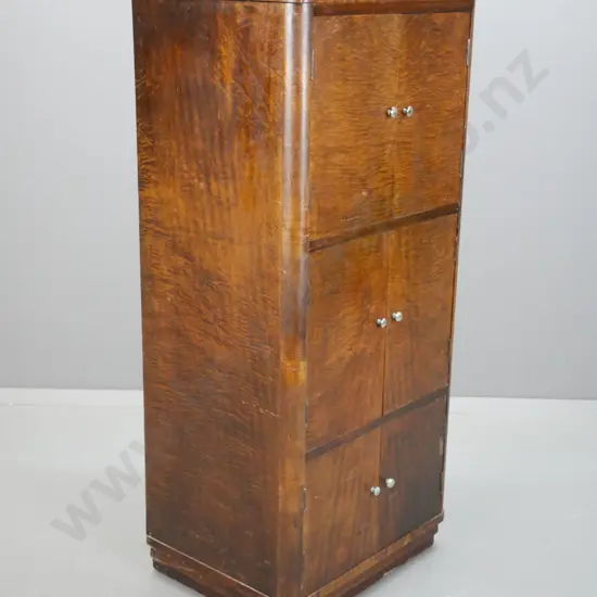 art deco figured laminate 6-door cabinet with rounded corners on plinth base, w/ chrome knobs. Some corrosion to knobs &