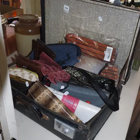 suitcase of clutch purses and wallets