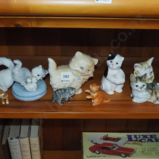 shelf of cat figurines