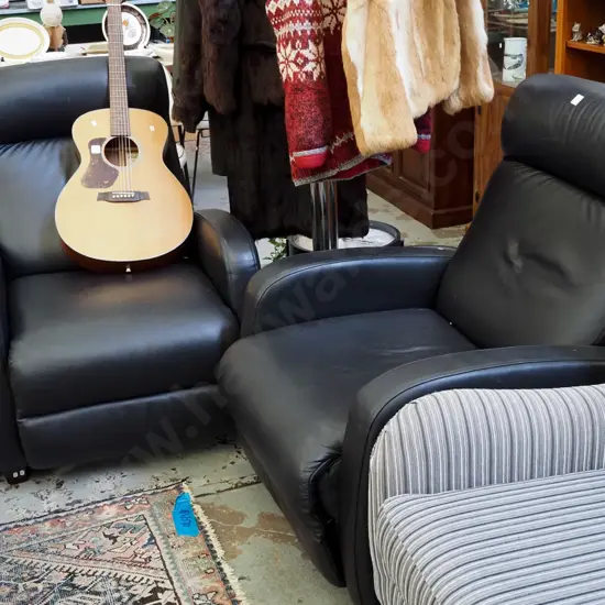 pair of black leather reclining armchairs