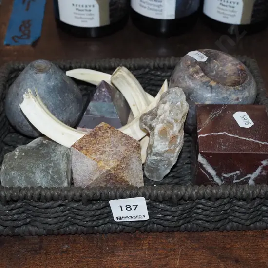 cane basket; animal tusks, stones, kauri gum