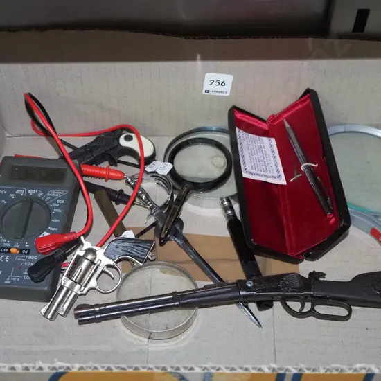 box; magnifying glasses, voltmeter, pen etc