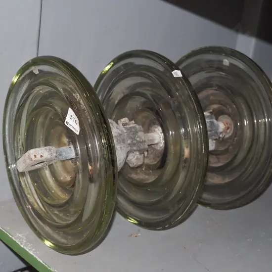 large glass and metal insulator