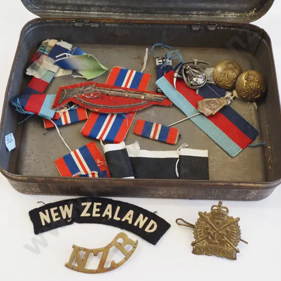 vintage tin of military badges