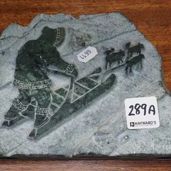 Canadian dog sled scene carving in marble
