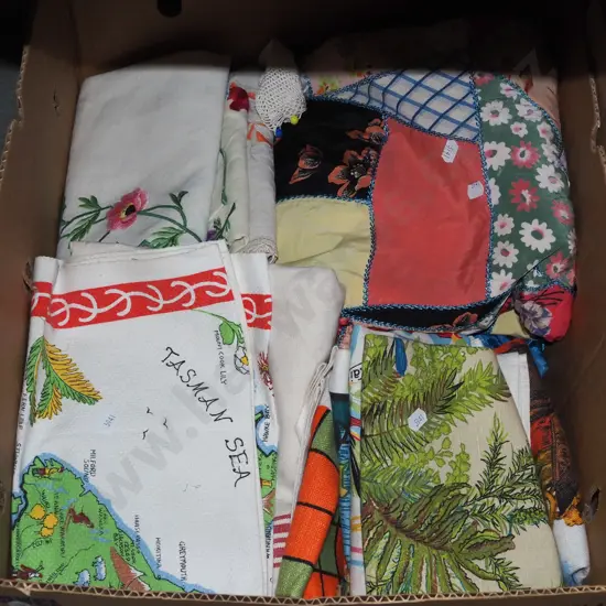 box of tea towels and a patchwork throw