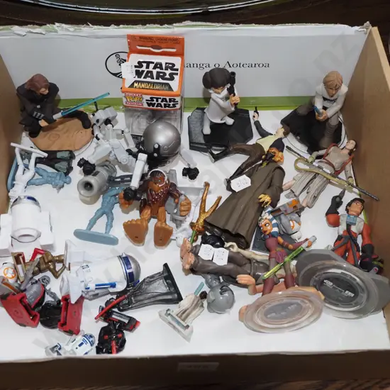 box of small Star Wars collectables and other toys