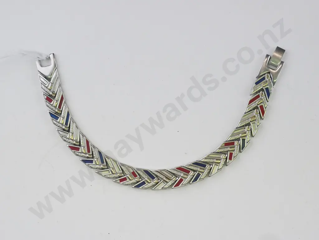 Silver bracelet, links in a chevron pattern. Some links are gold, blue and red. Image 1++