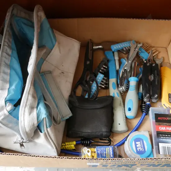 Blue Toolbag containing wires, pliers, hammer, multi tool, craft knife and other various tools and items.