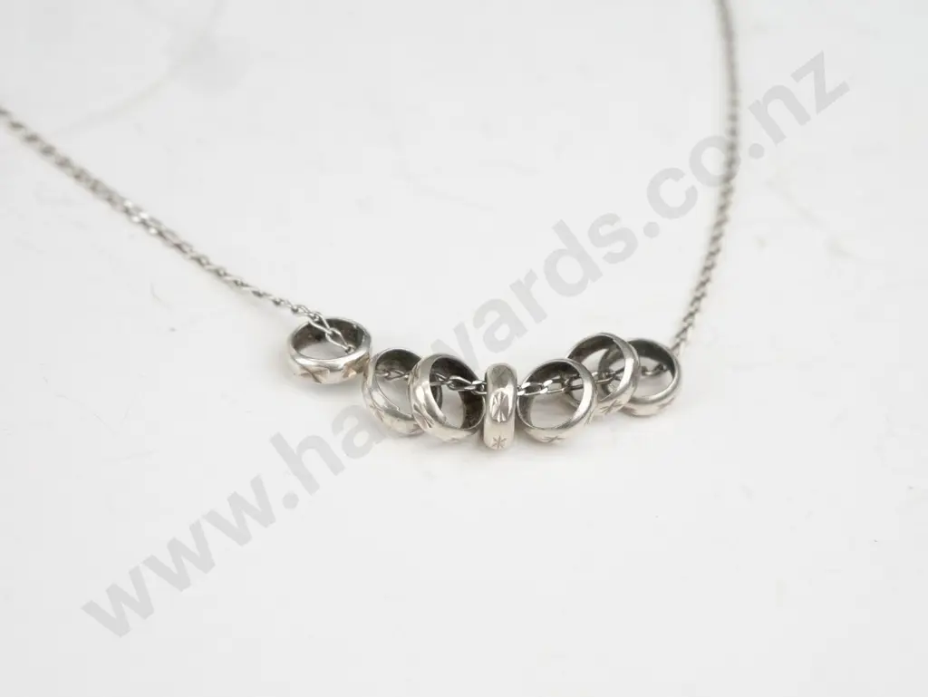 Thin silver necklace with 7 small rings Image 1++