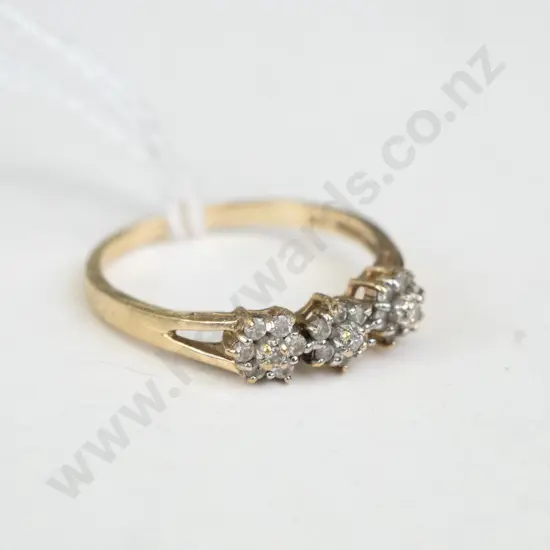 Gold coloured ring with 3 x clusters of white stones on top