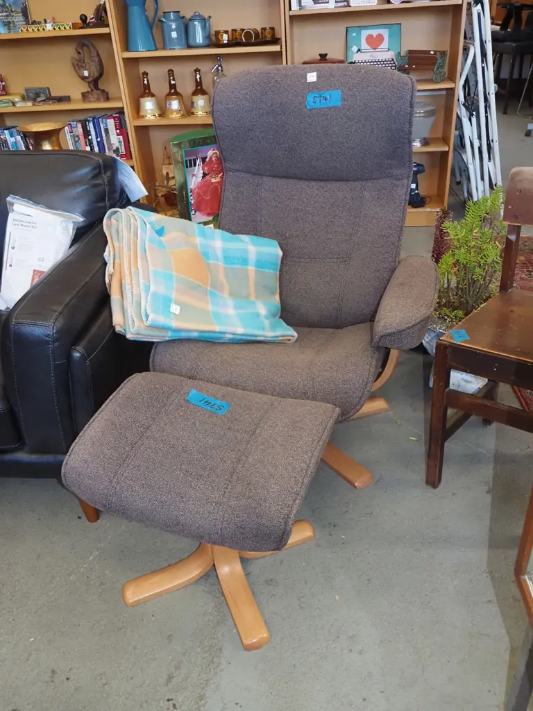 brown upholstered swivel chair with footstool Image 1++