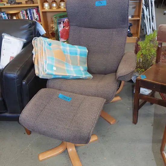 brown upholstered swivel chair with footstool