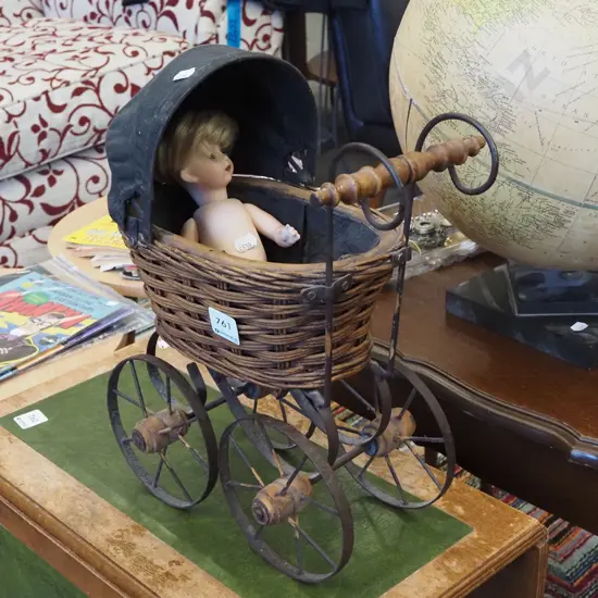 porcelain doll and pram