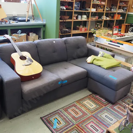 charcoal upholstered L shaped couch - significant fading - L shape can be moved around