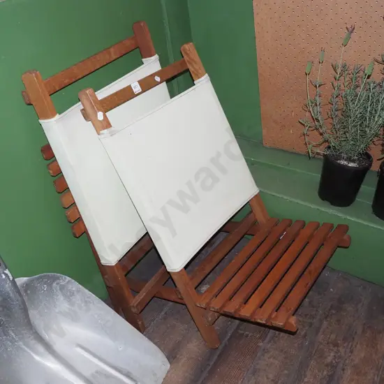 pair of hardwood and canvas beach chairs