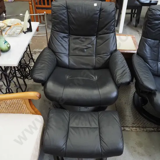 black vinyl Stressless swivel reclining armchair with matching footstool