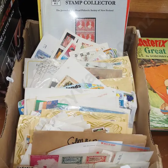 box of stamps and stamp reference books