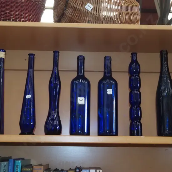 7x blue glass bottles H330