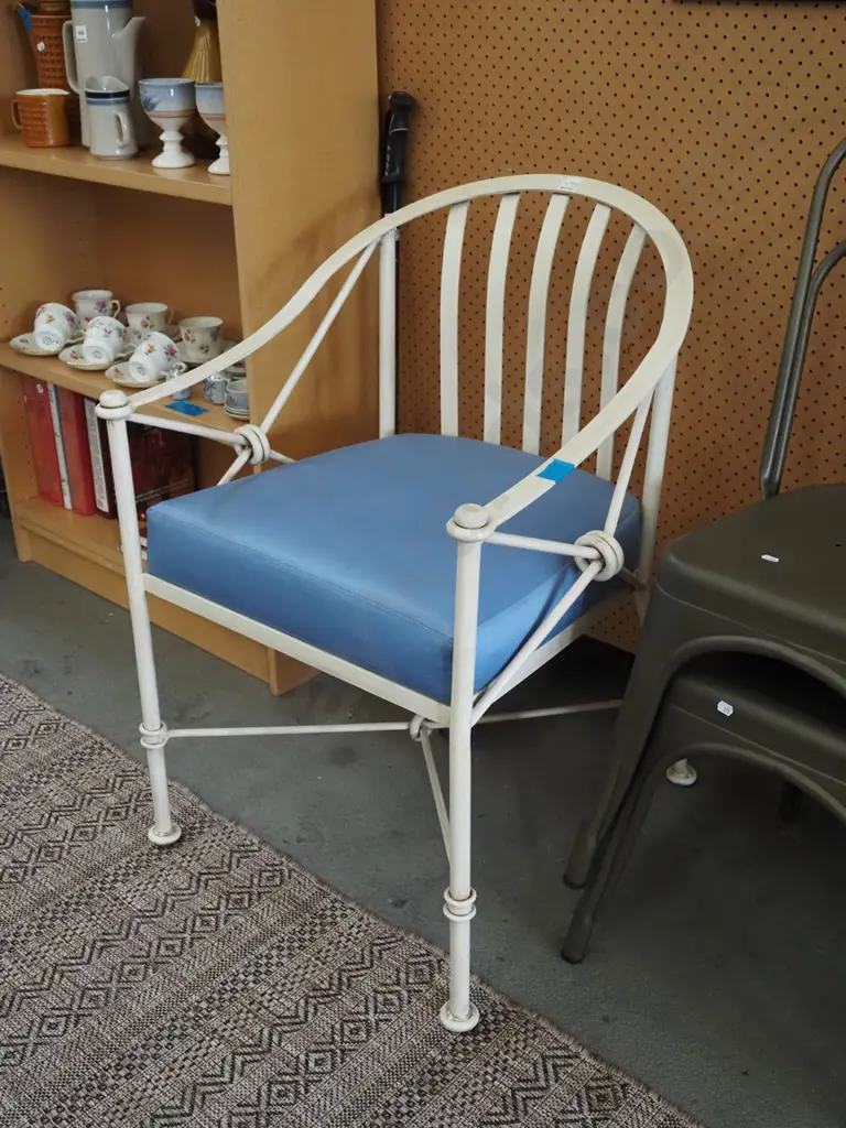 heavy metal framed tub chair with blue cushion Image 1++