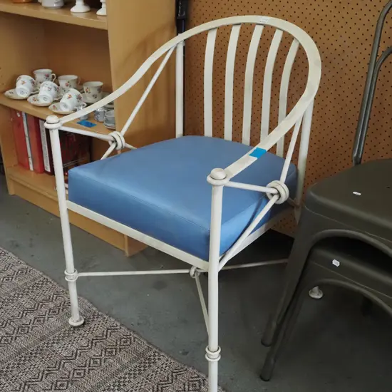 heavy metal framed tub chair with blue cushion