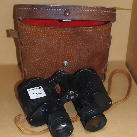 pair of field binoculars in leather case