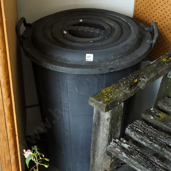 large black plastic lidded rubbish bin