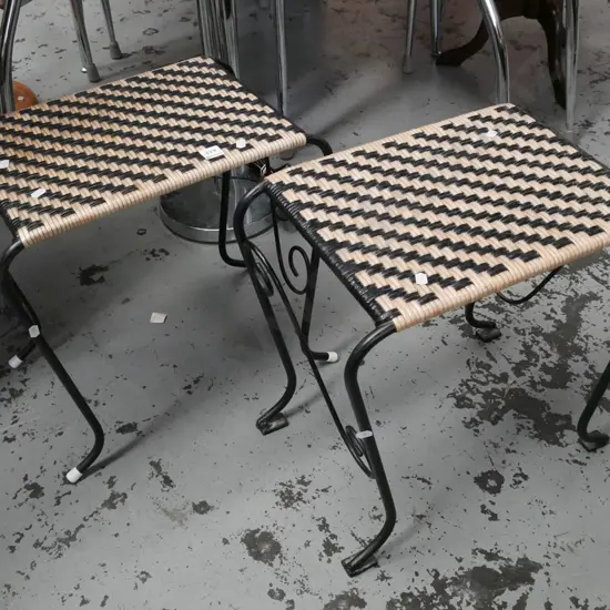 pair of wrought metal and woven plastic stools