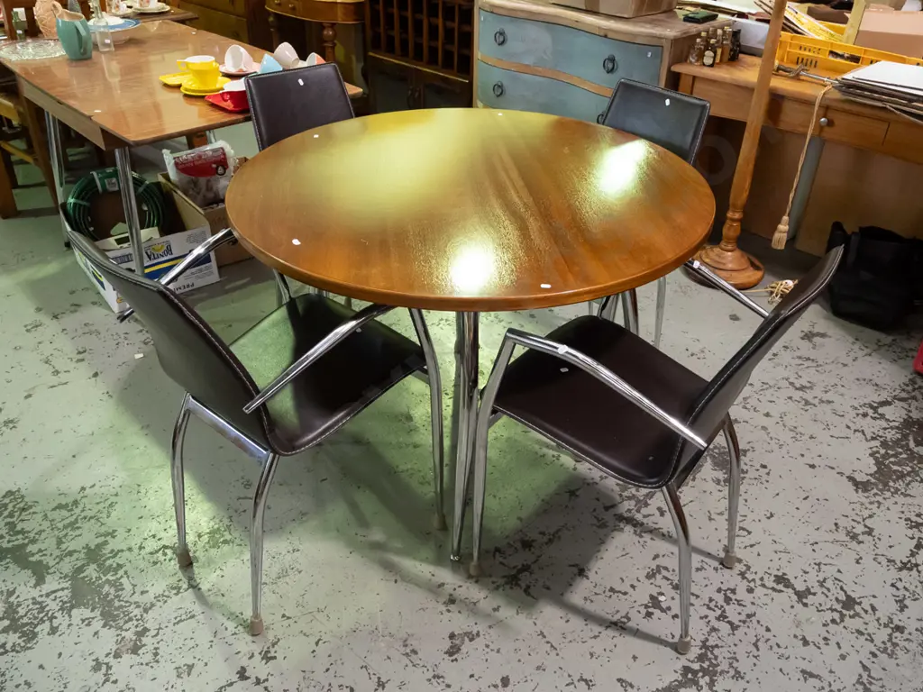 circular chrome based glass top dining table with 4 matching vinyl chairs - glass top table has mahogany Image 1++