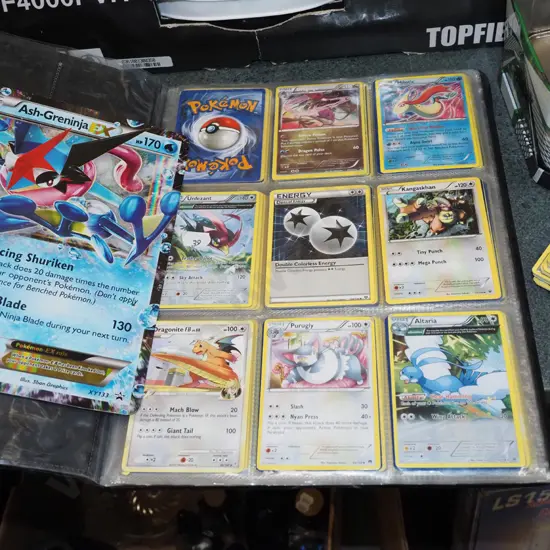 Pokemon cards in tin and album