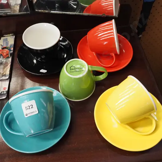 coloured ceramic coffee cups and saucers