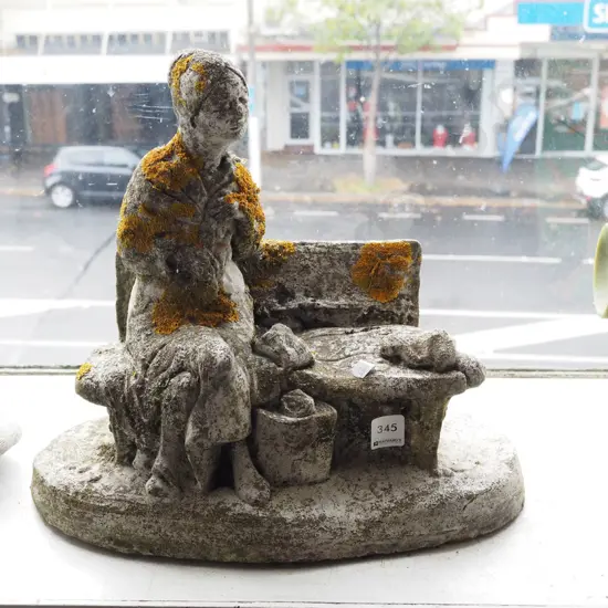 cast concrete figurine - woman on bench H330