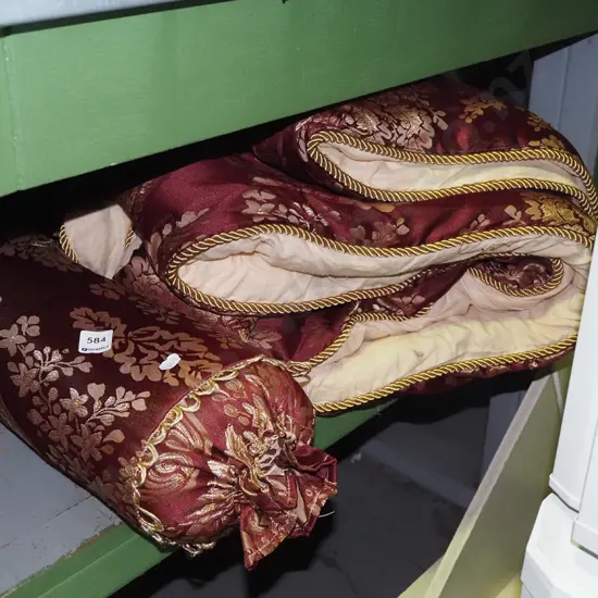 red and gold bedspread and cushion