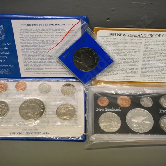 2 New Zealand coin sets -  1982 souvenir set and 1985 proof set - and a cased 1982 dollar