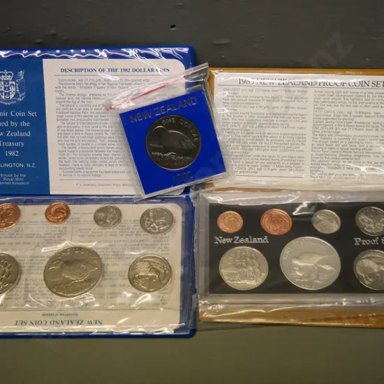 2 New Zealand coin sets -  1982 souvenir set and 1985 proof set - and a cased 1982 dollar