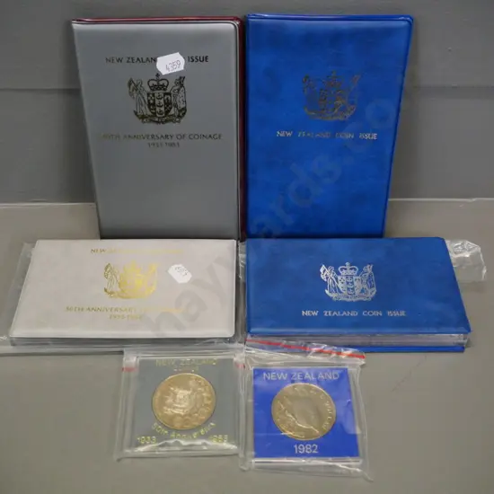 4 New Zealand collector coin sets: 1982 and 1983 cased proof sets and souvenir sets, 2 cased dollars