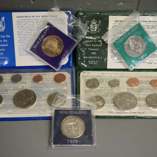 2 New Zealand coin sets - 1978 and 1980, and 3 individual cased dollars 1978, 79, and 80