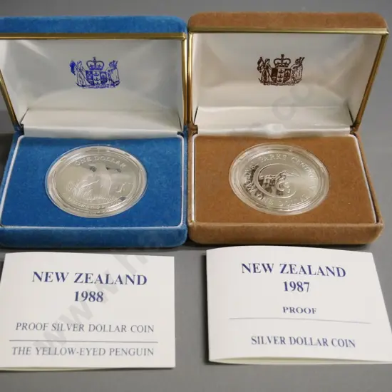 2 cased New Zealand silver dollars - 1987 National Parks and 1988 Yellow Eyed Penguin