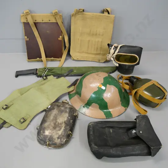 WWII era military equipment - tin helmet, gas mask, puttees, water bottle, rusty machete, etc.