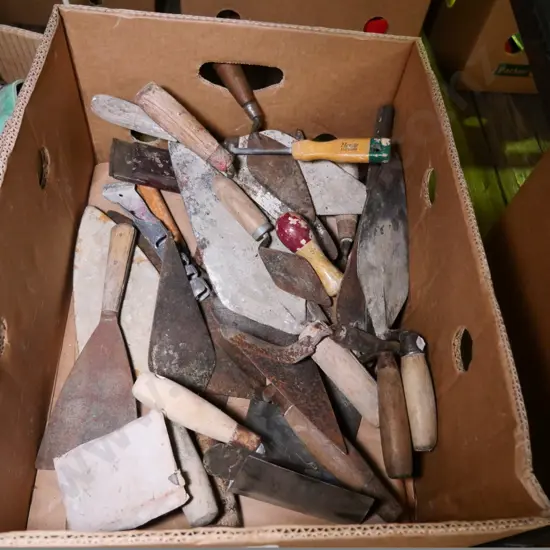 box of rusty trowels