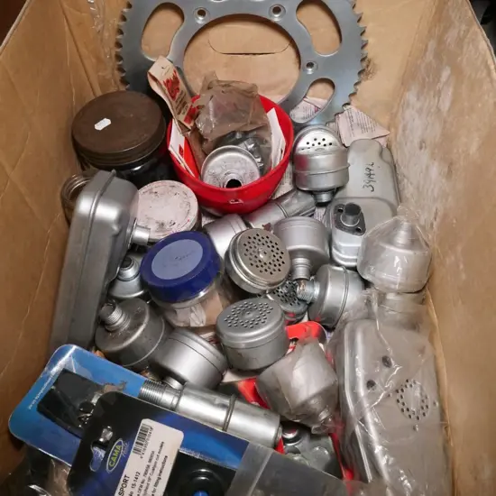 box of lawnmower parts, mufflers, etc.