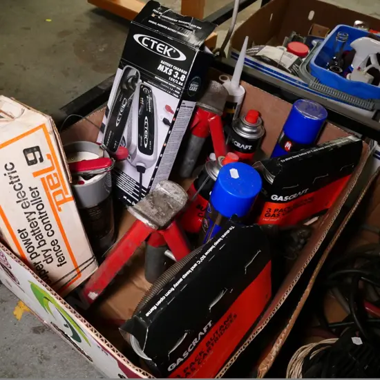 box of axle stands, battery charger, gas cartridges, etc.
