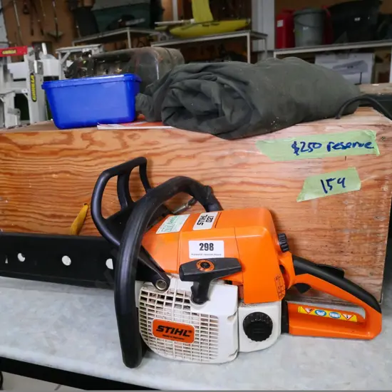 Stihl 021 chainsaw with wooden carry case, safety trousers, etc.