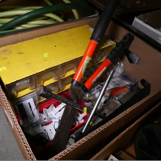 box of hedge trimmers, car jack, small storage drawers, etc.