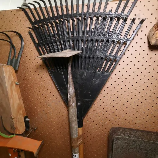 2 grass rakes and a hoe