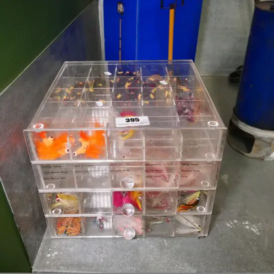 set of perspex drawers with numerous fishing lures