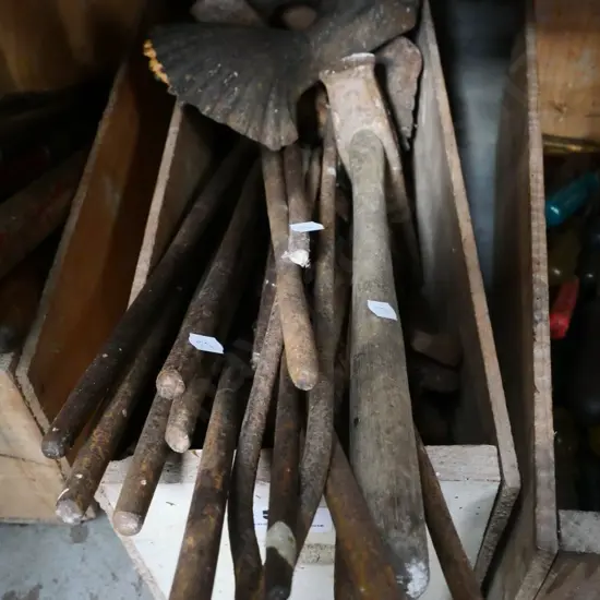 box of cast iron bath feet, blacksmith's tools etc.