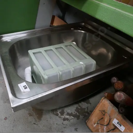stainless steel laundry sink and small set of plastic drawers